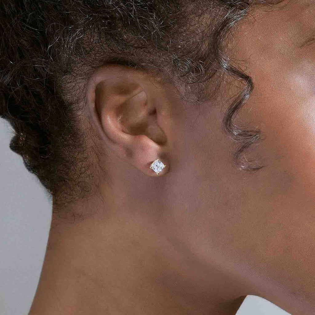 Model wearing Jewellers District's Asscher-Cut Diamond Stud Earrings in 14k Yellow Gold, Lab-grown 1.40 ctw, VS2+/ F+ #4