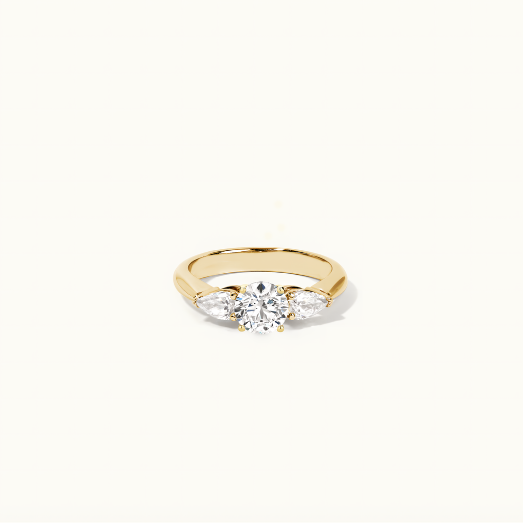 Jewellers District's Three-Stone Diamond Engagement Ring with Side Pear Diamonds in 14k Yellow Gold, Round