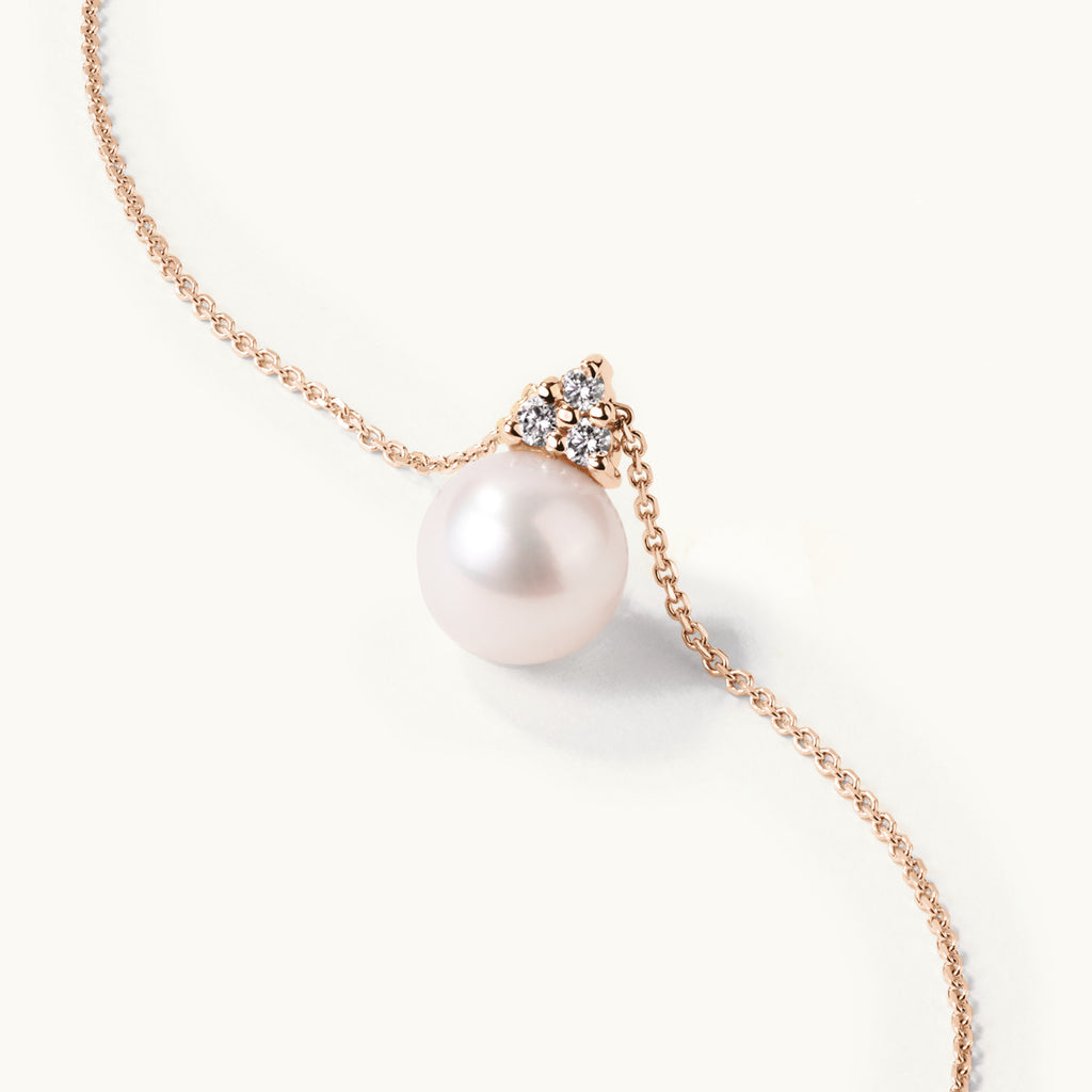 Angled view of Jewellers District's Freshwater Pearl Pendant Necklace with Accent Diamonds in 14k Rose Gold