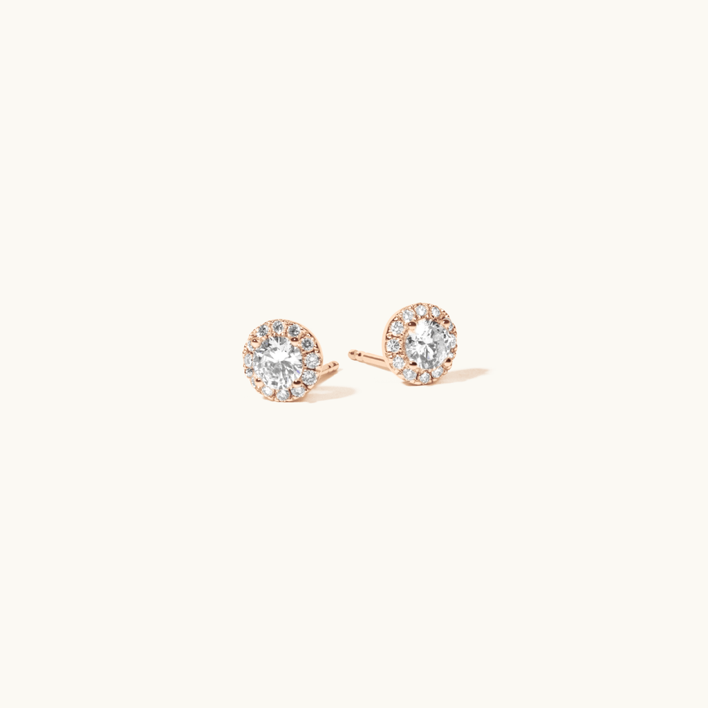 Angled view of Jewellers District's Diamond Halo Stud Earrings in 14k Rose Gold