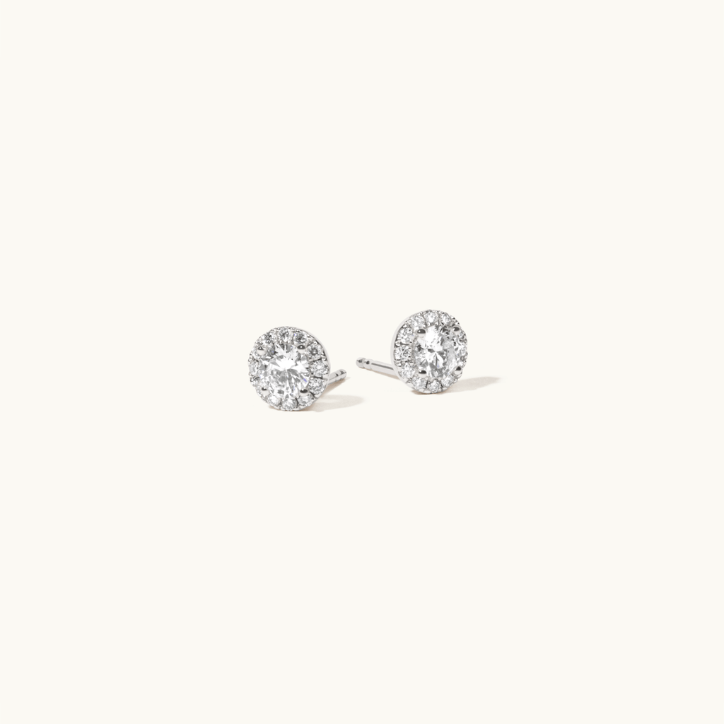 Angled view of Jewellers District's Diamond Halo Stud Earrings in 14k White Gold