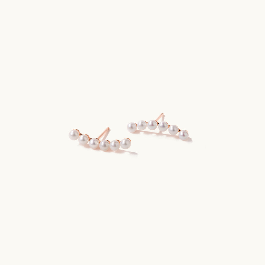 Angled view of Jewellers District's Freshwater Pearl Crawler Earrings in 10k Rose Gold