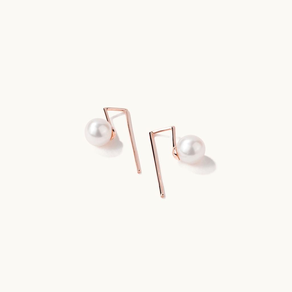 Angled view of Jewellers District's Freshwater Pearl Drop Earrings in 14k Rose Gold