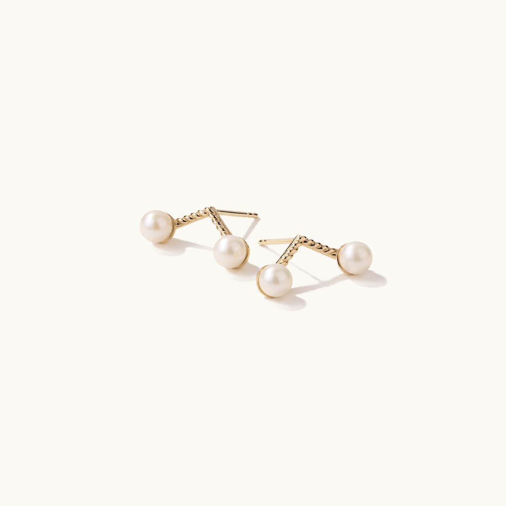 Angled view of Jewellers District's Cherry Stem Freshwater Pearl Earrings in 10k Yellow Gold