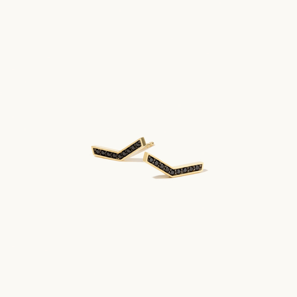 Angled view of Jewellers District's V-Shaped Stud Earrings with Accent Black Spinels in 14k Yellow Gold