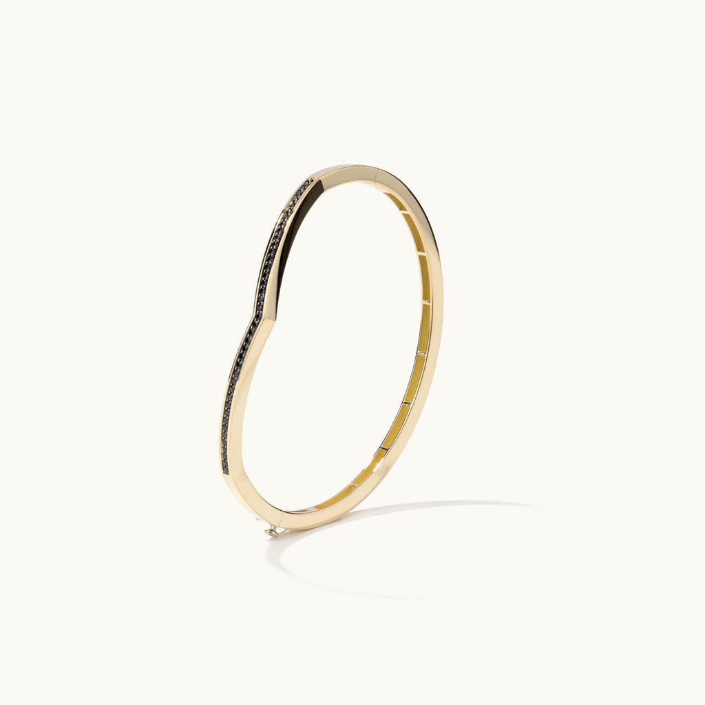 Profile view of Jewellers District's V-Shaped Gold Bangle with Black Spinels in 14k Yellow Gold