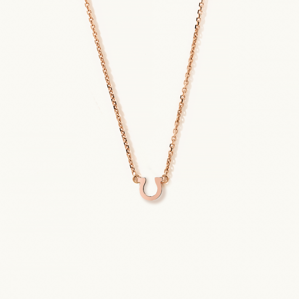 Face view of Jewellers District's Petite Gold Horseshoe Pendant Necklace in 14k Rose Gold