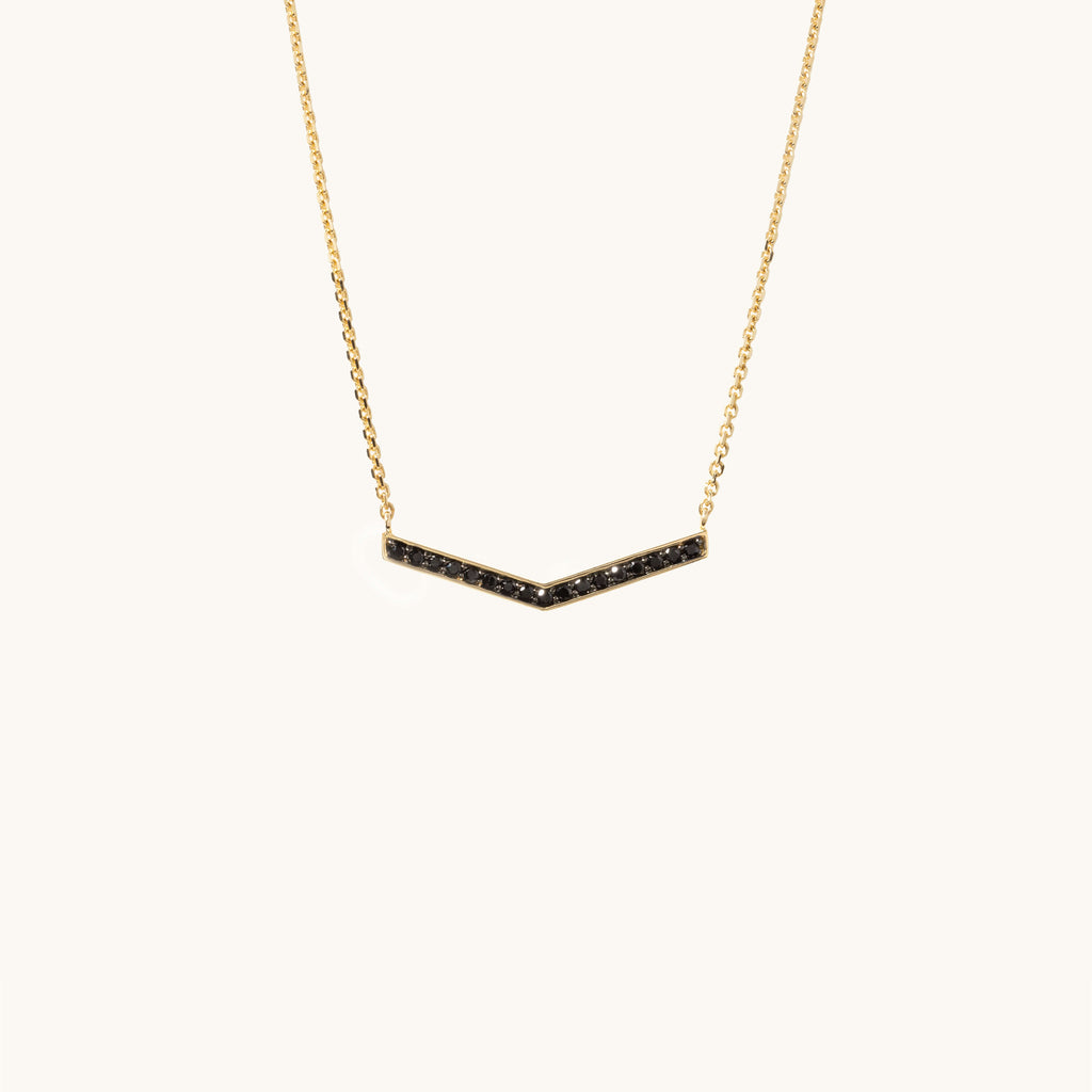 Face view of Jewellers District's V-Shaped Gold Pendant Necklace with Black Spinels in 14k Yellow Gold