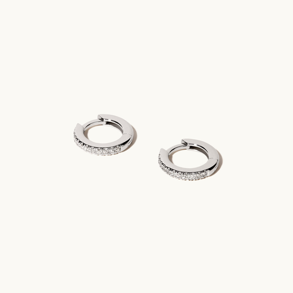 Angled view of Jewellers District's Diamond Hoop Earrings in 14k White Gold