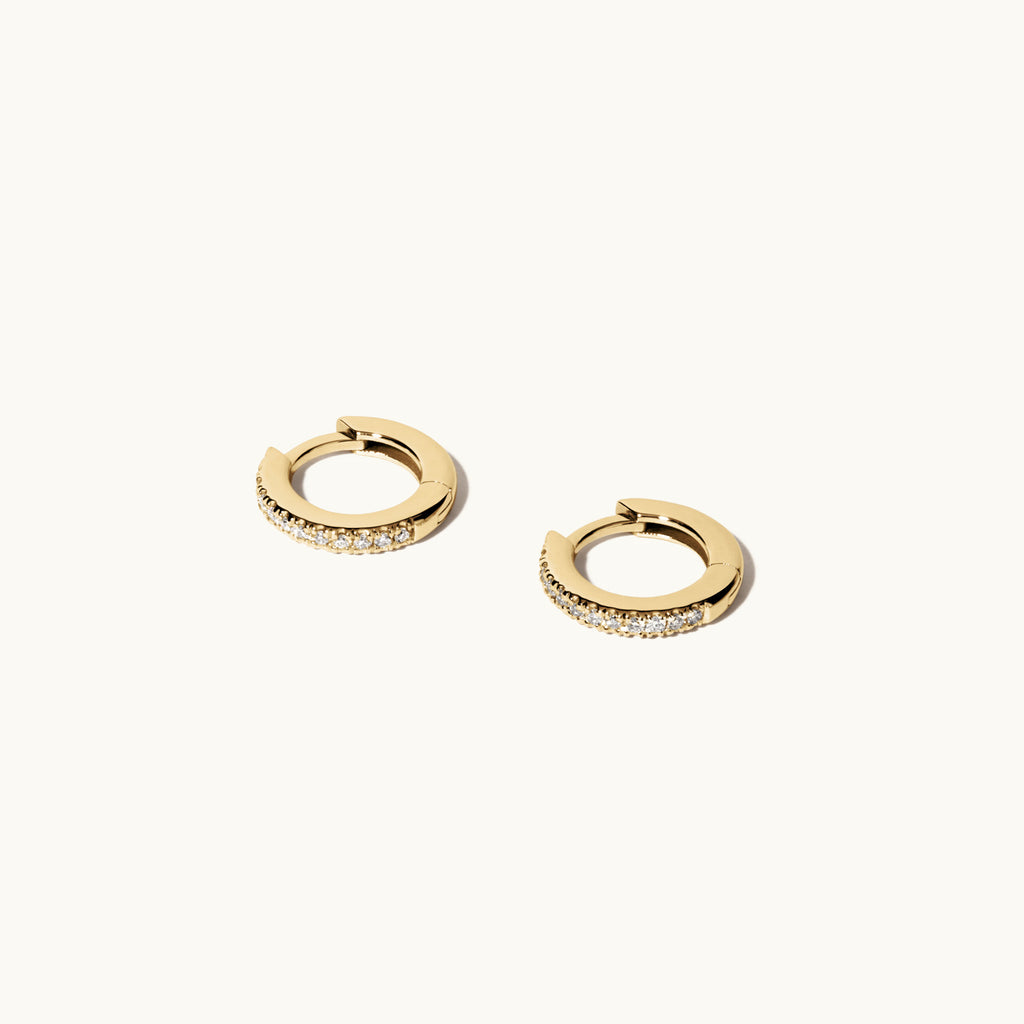 Angled view of Jewellers District's Diamond Hoop Earrings in 14k Yellow Gold