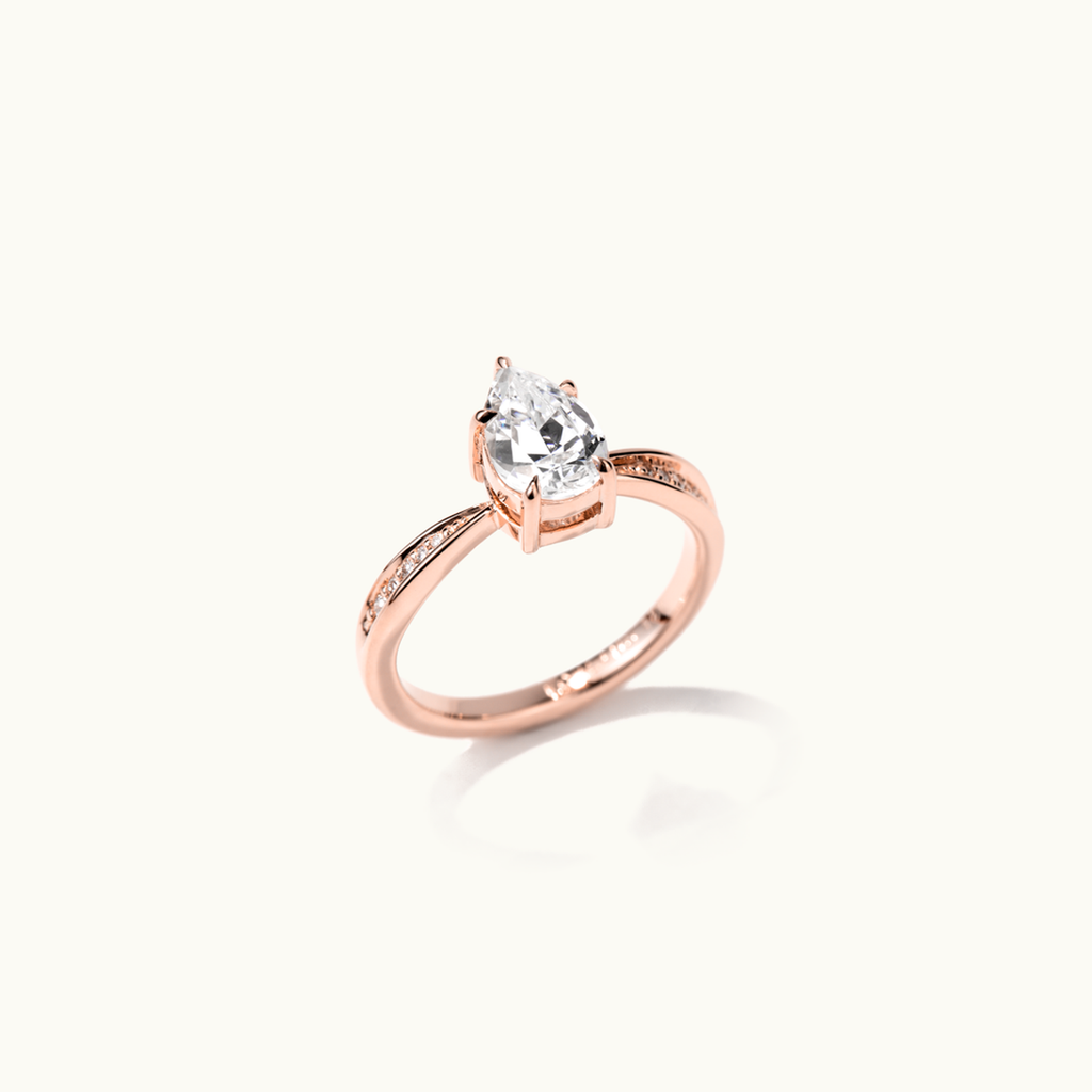 Angled view of Jewellers District's Five-Prong Diamond Engagement Ring with Diamond Pavé in 14k Rose Gold, Pear