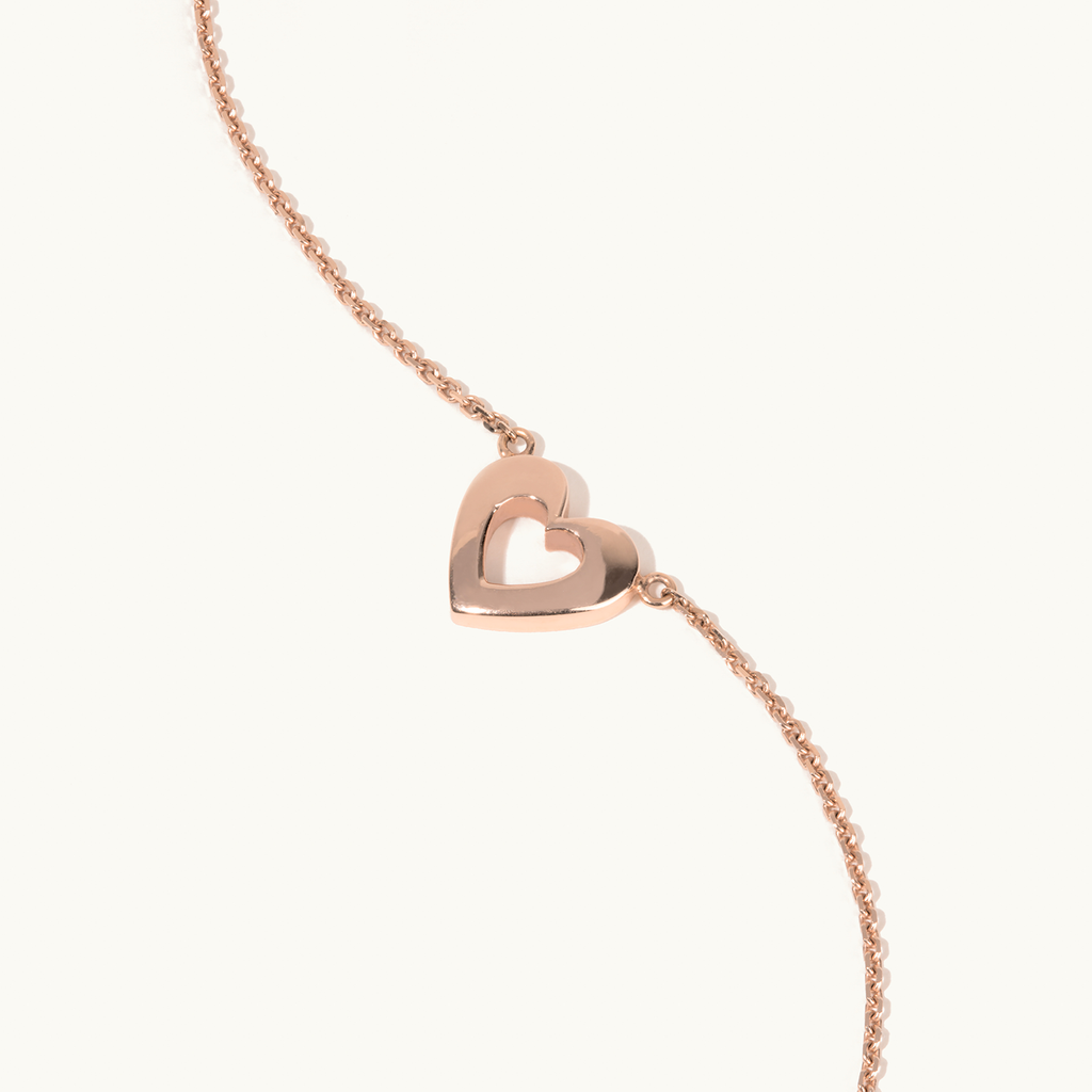 Angled view of Jewellers District's Gold Heart Pendant Necklace in 14k Rose Gold