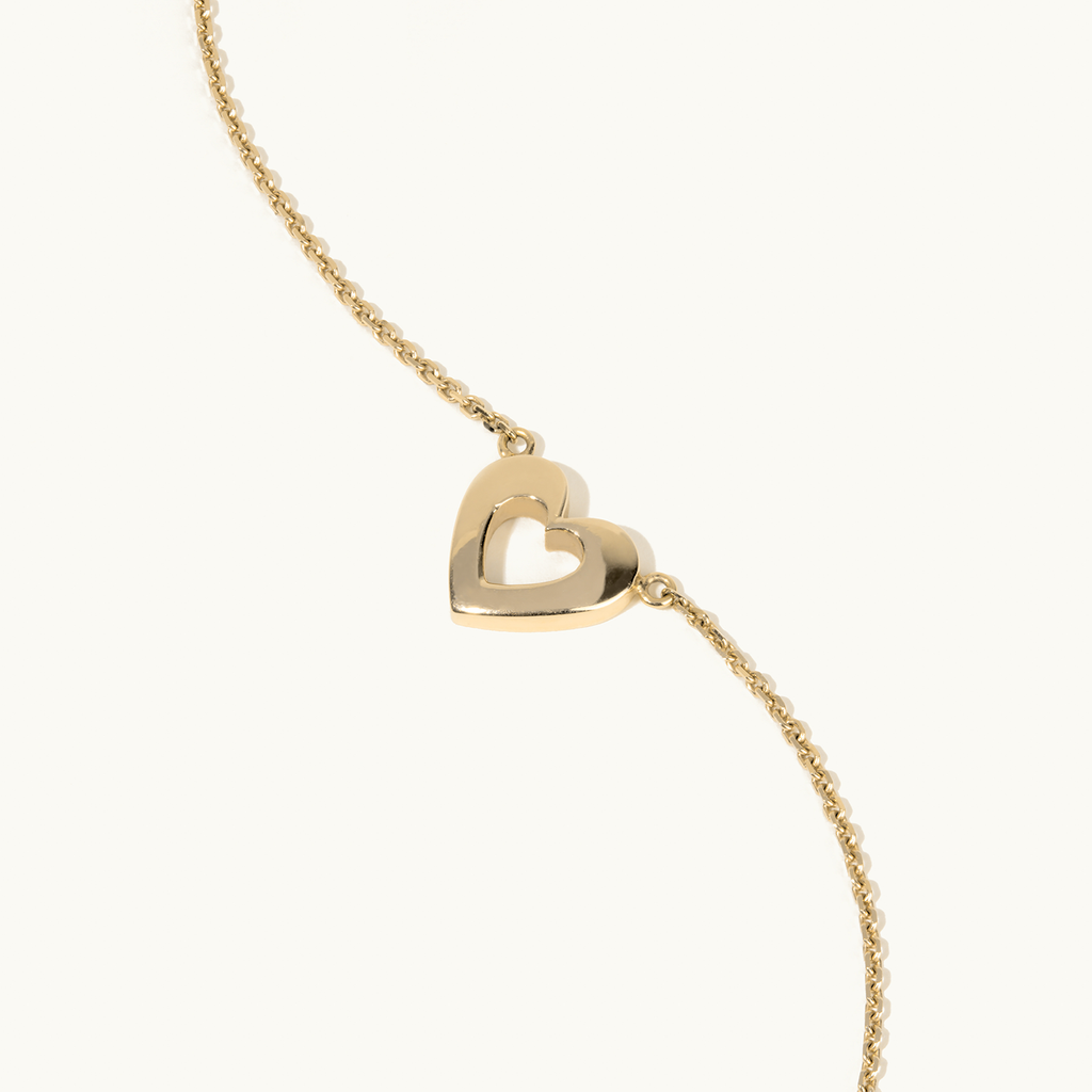 Angled view of Jewellers District's Gold Heart Pendant Necklace in 14k Yellow Gold