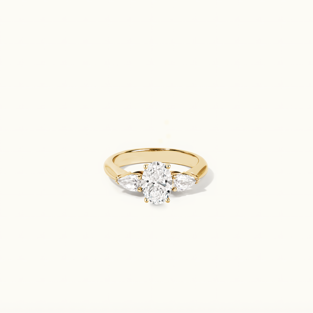 Jewellers District's Three-Stone Diamond Engagement Ring with Side Pear Diamonds in 14k Yellow Gold, Oval