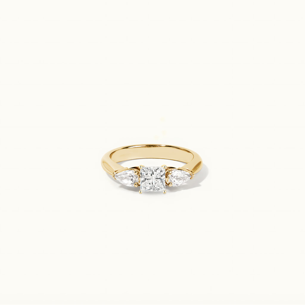 Jewellers District's Three-Stone Diamond Engagement Ring with Side Pear Diamonds in 14k Yellow Gold, Princess