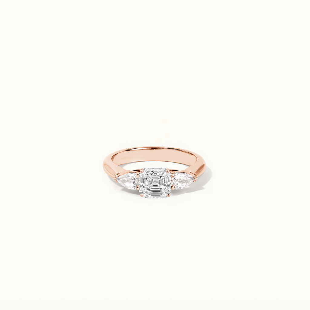 Jewellers District's Three-Stone Diamond Engagement Ring with Side Pear Diamonds in 14k Rose Gold, Asscher