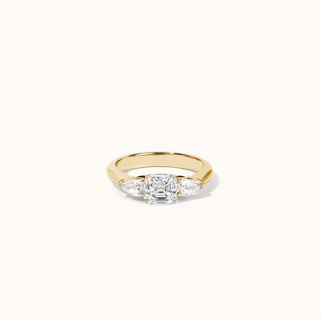 Jewellers District's Three-Stone Diamond Engagement Ring with Side Pear Diamonds in 14k Yellow Gold, Asscher