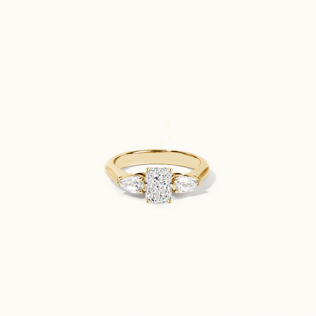 Jewellers District's Three-Stone Diamond Engagement Ring with Side Pear Diamonds in 14k Yellow Gold, Radiant