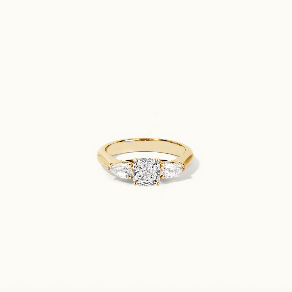 Jewellers District's Three-Stone Diamond Engagement Ring with Side Pear Diamonds in 14k Yellow Gold, Cushion