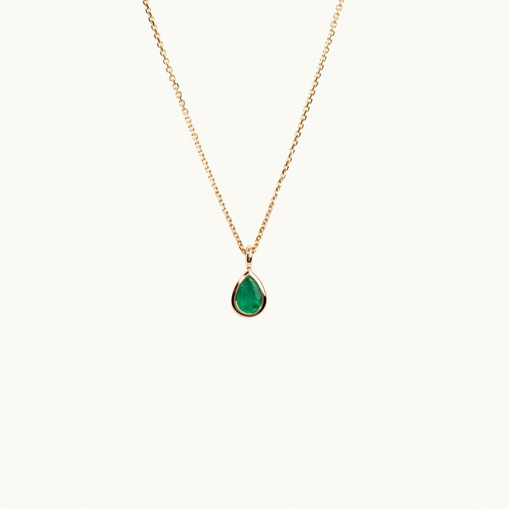 Face view of Jewellers District's Bezel Set Pear-Cut Emerald Pendant Necklace in 14k Yellow Gold