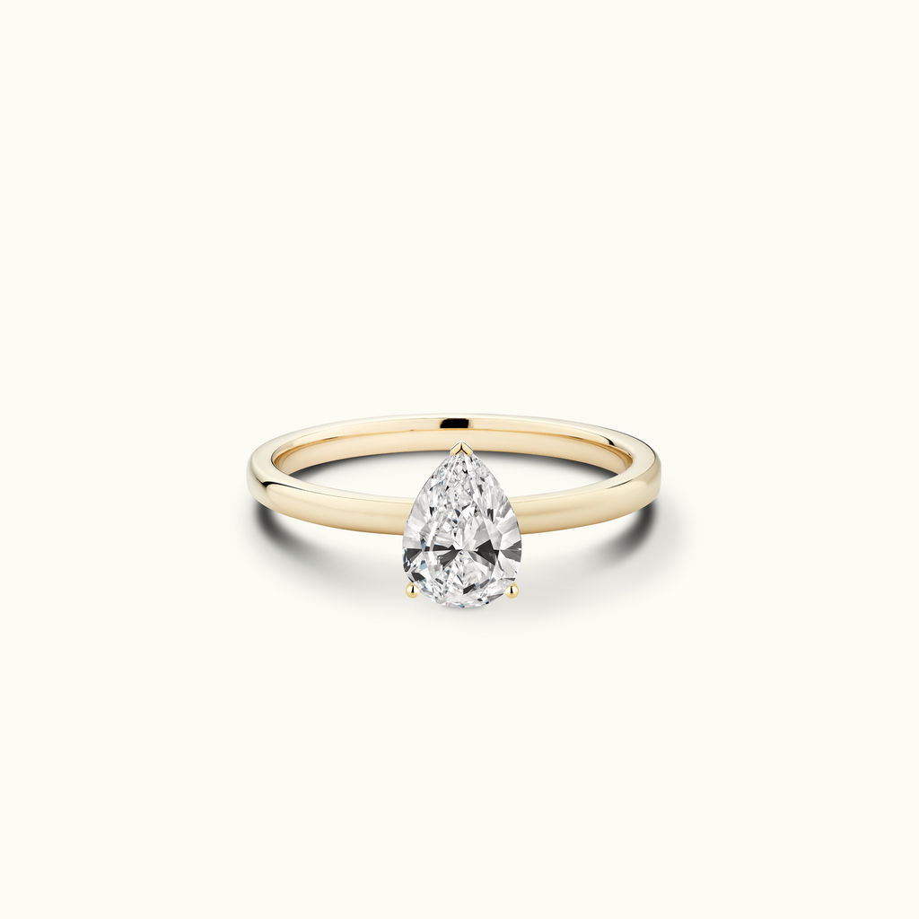 Jewellers District's Diamond Engagement Ring with Signature Knot-Basket and Accent Diamonds in 14k Yellow Gold, Pear