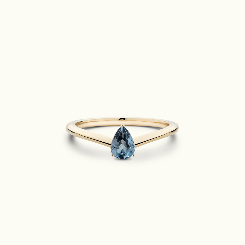 Model wearing Jewellers District's V-Shaped Pear Cut Aquamarine Engagement Ring in 14k Yellow Gold, Pear