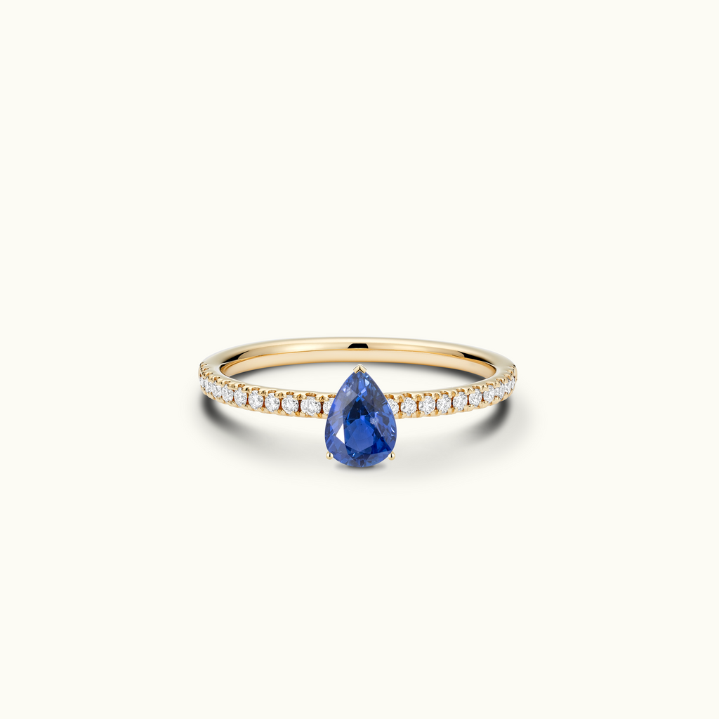 Jewellers District's Royal Sapphire Engagement Ring with Signature Knot-Basket and Diamond Band in 14k Yellow Gold, Pear