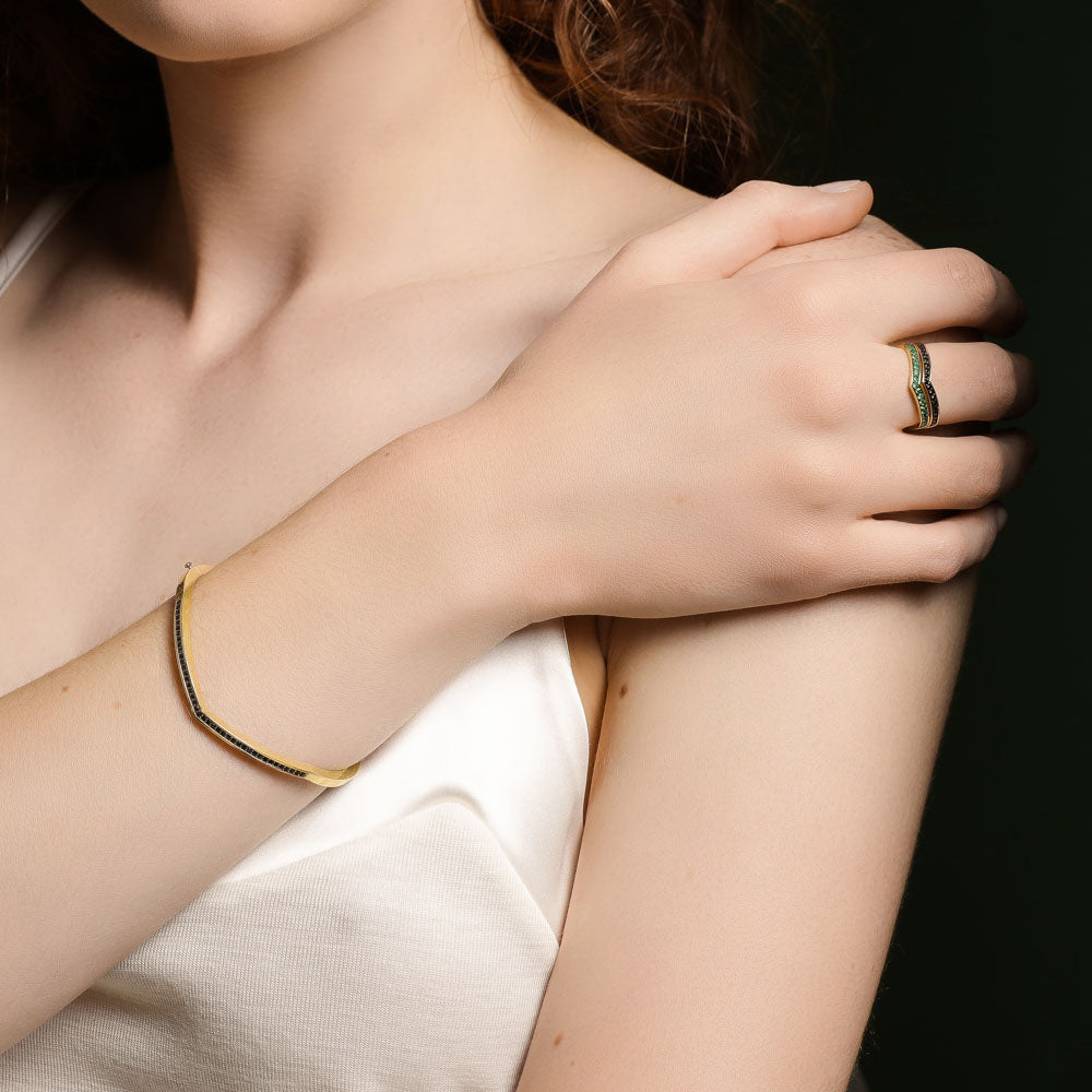 Model wearing Jewellers District's V-Shaped Gold Bangle with Black Spinels in 14k Yellow Gold #2