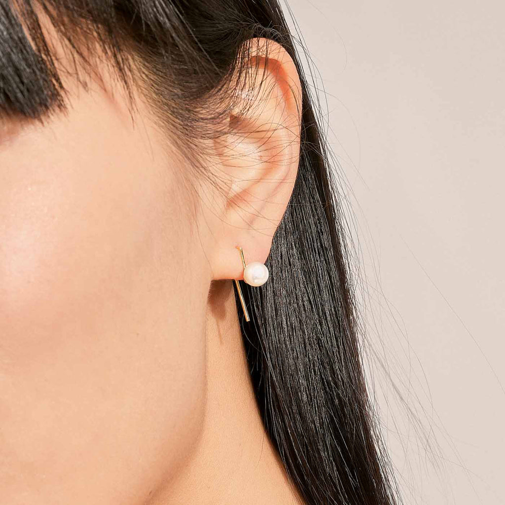 Model wearing Jewellers District's Freshwater Pearl Drop Earrings in 14k Yellow Gold