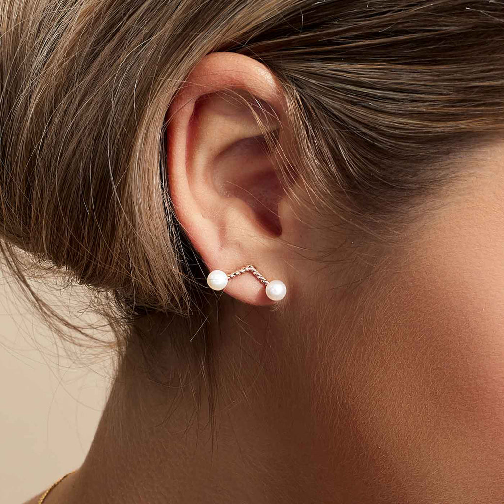 Model wearing Jewellers District's Cherry Stem Freshwater Pearl Earrings in 14k Rose Gold #2