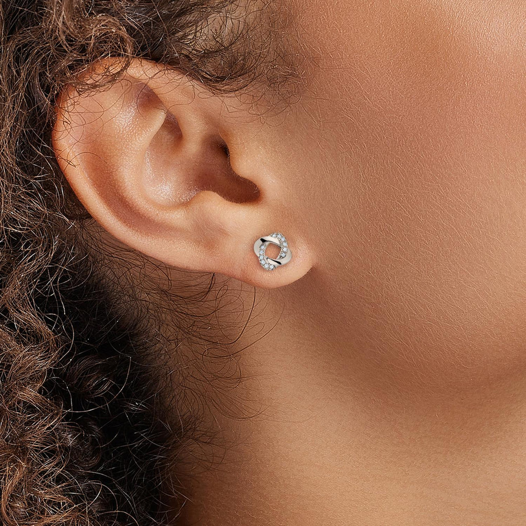 Model wearing Jewellers District's Twisted Diamond Pavé Studs in 10k White Gold