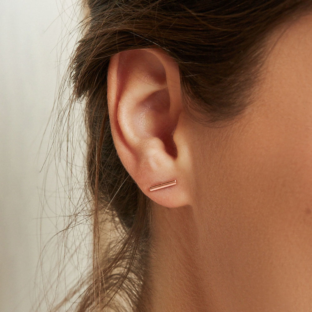 Model wearing Jewellers District's Gold Bar Stud Earrings in 10k Rose Gold #4