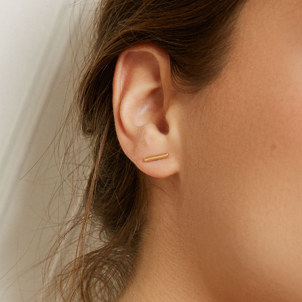 Model wearing Jewellers District's Gold Bar Stud Earrings in 10k Yellow Gold