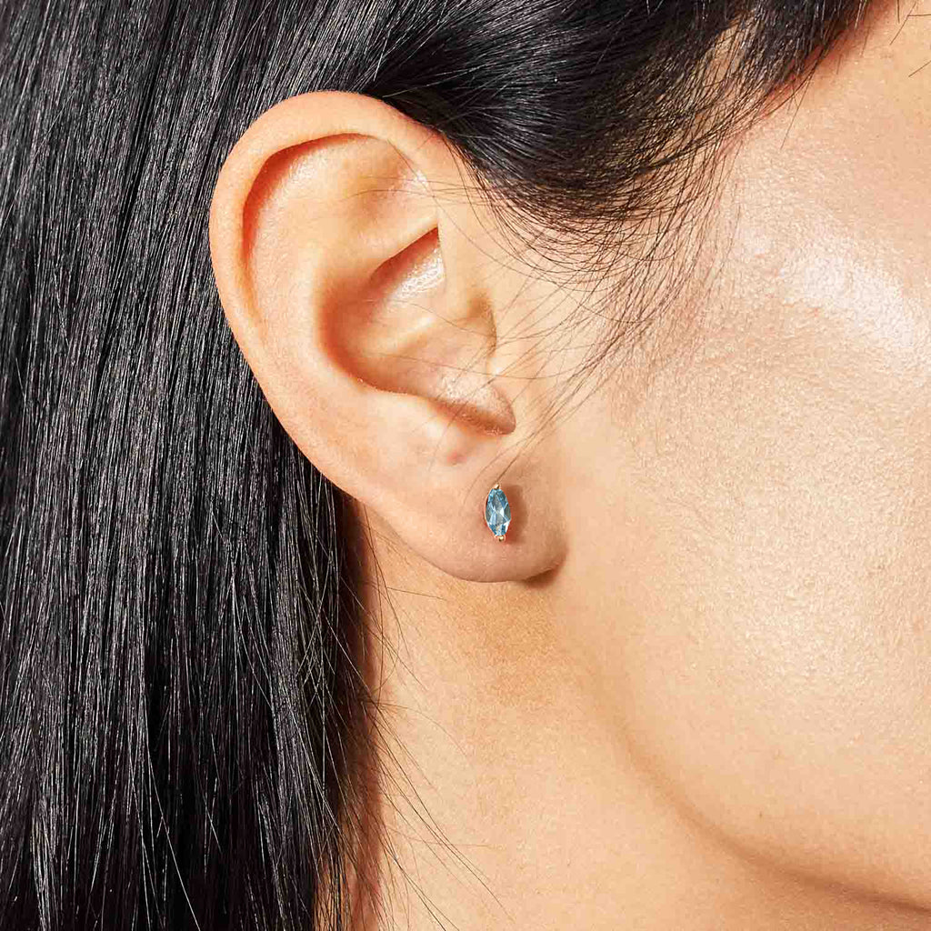 Model wearing Jewellers District's Marquise Cut Aquamarine Studs in 14k Yellow Gold