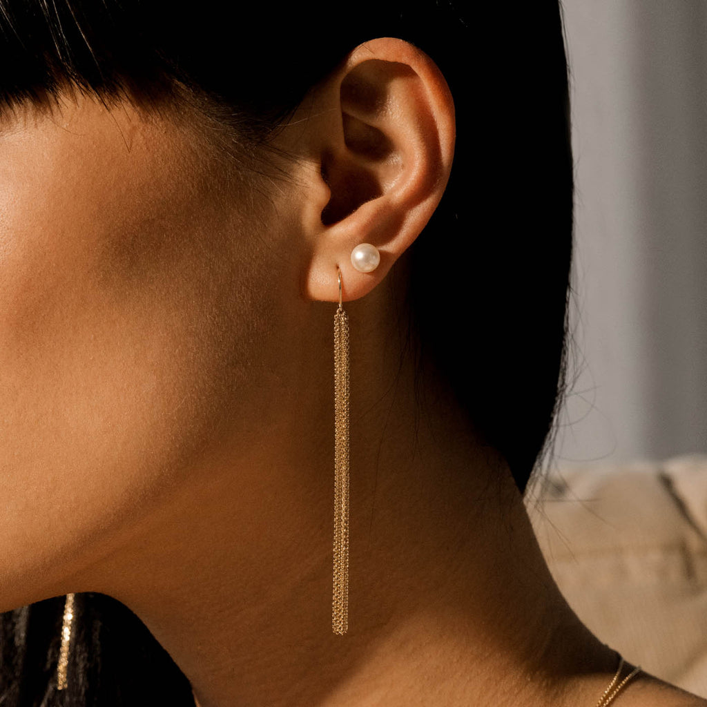 Model wearing Jewellers District's Freshwater Pearl Stud Earrings in 14k Yellow Gold #2