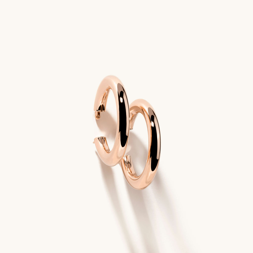 Angled view of Jewellers District's Thick Gold Hoop Earrings in 14k Rose Gold