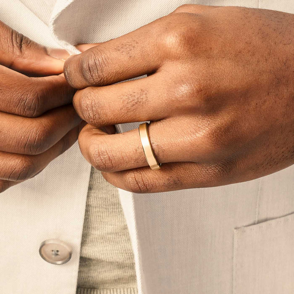 Model wearing Jewellers District's Flat Brushed Wedding Ring in 14k Yellow Gold, Band: 5mm #3