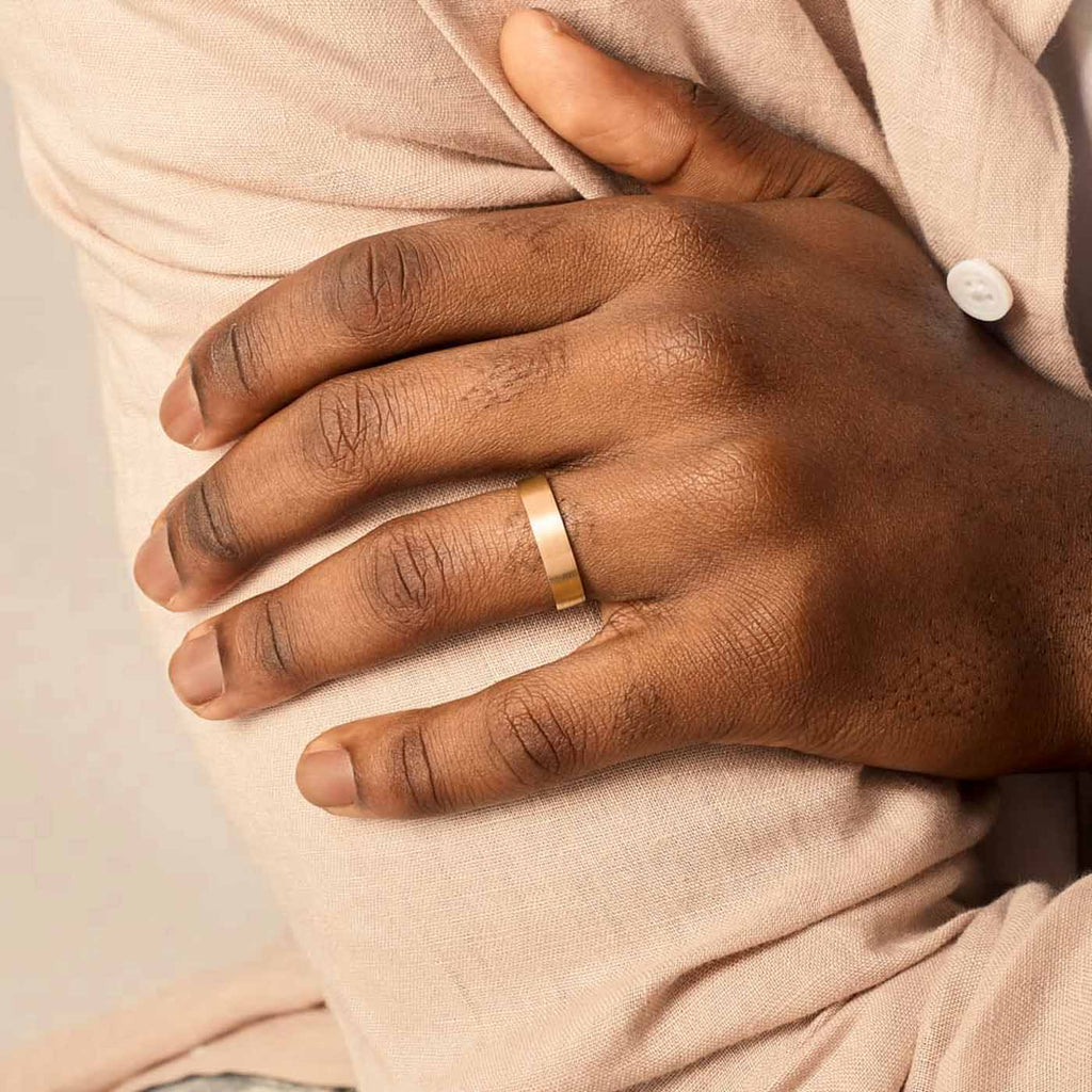 Model wearing Jewellers District's Flat Brushed Wedding Ring in 14k Yellow Gold, Band: 5mm #4