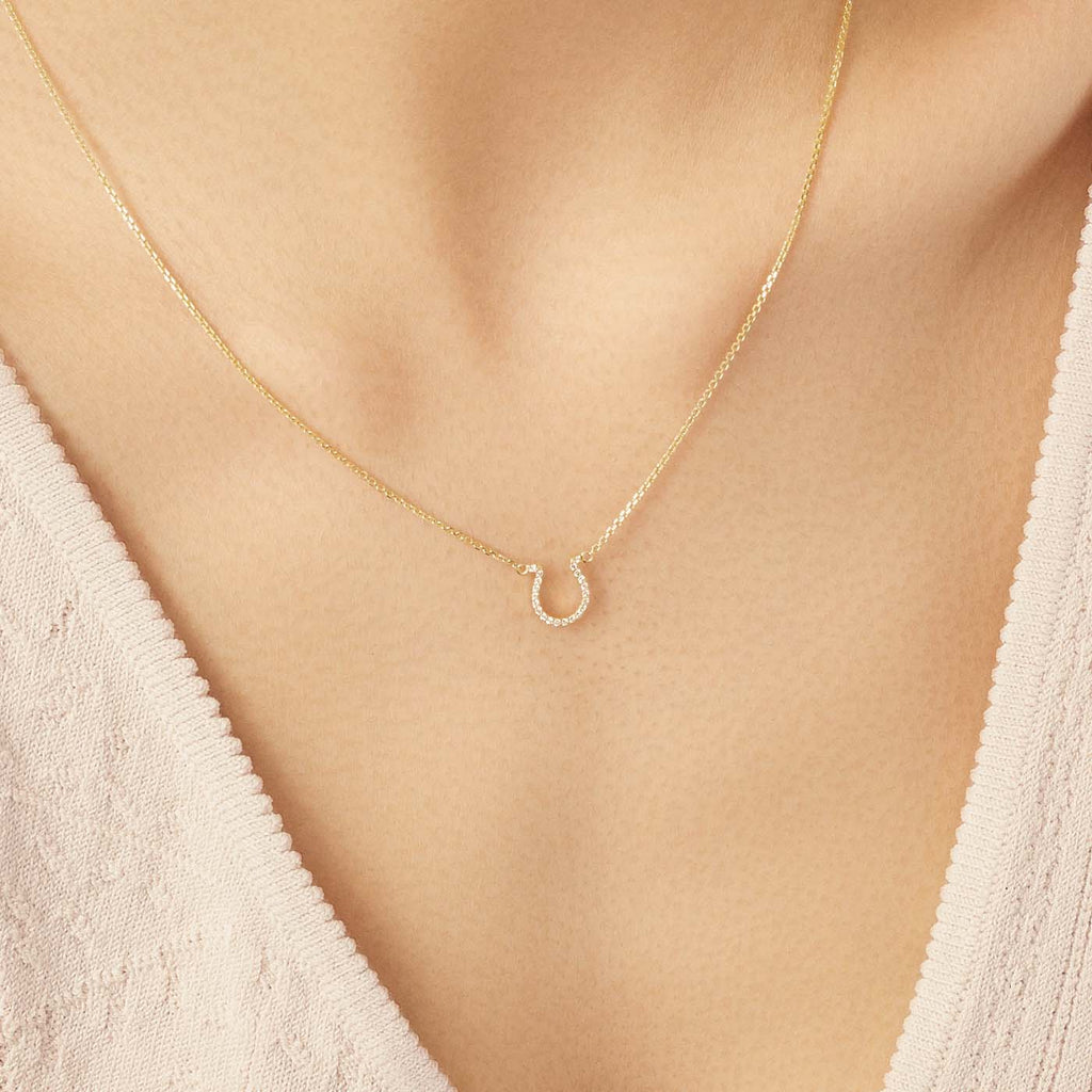 Model wearing Jewellers District's Horseshoe Diamond Pavé Pendant Necklace in 10k Yellow Gold #2