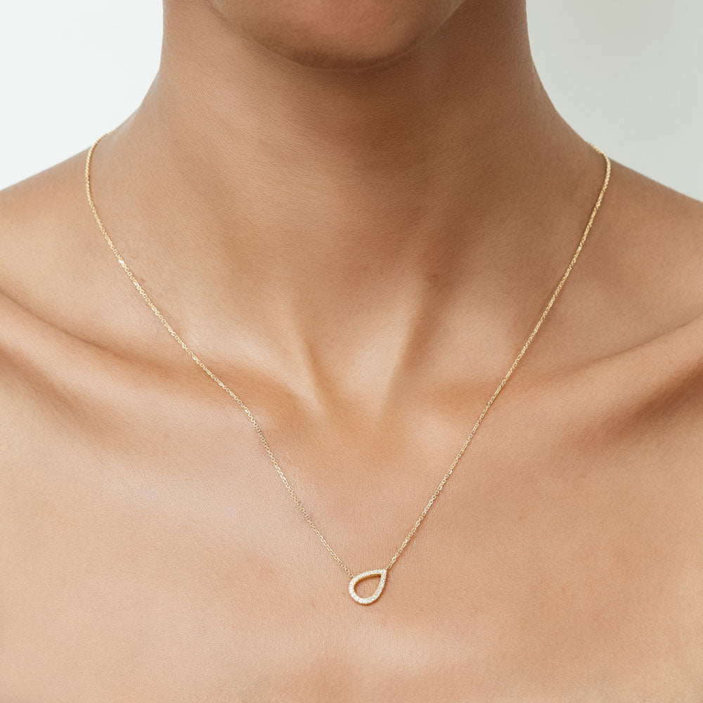 Model wearing Jewellers District's Pear Diamond Pavé Pendant Necklace in 10k Yellow Gold