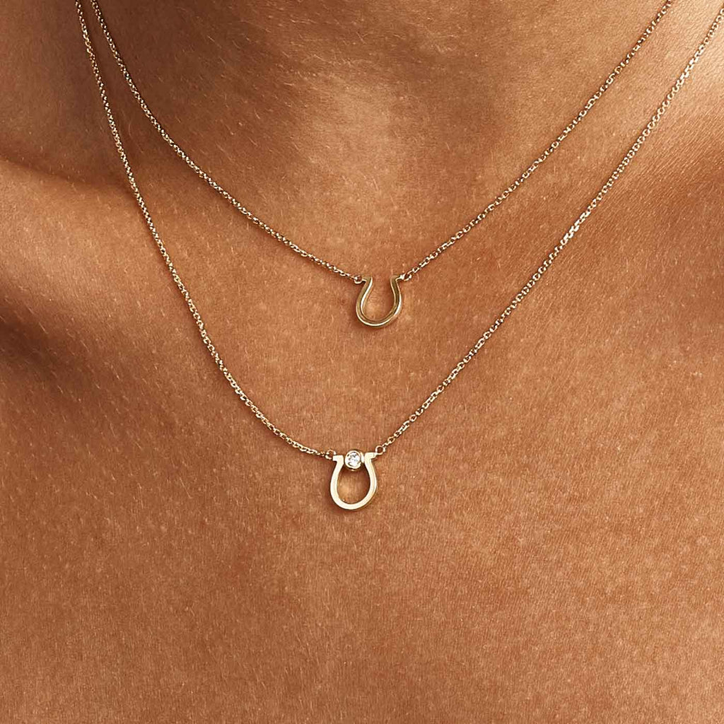 Model wearing Jewellers District's Gold Horseshoe Pendant Necklace in 14k Yellow Gold #4