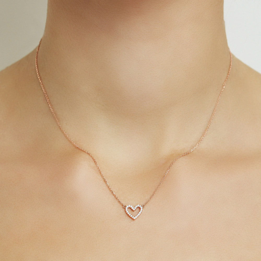 Model wearing Jewellers District's Heart Diamond Pavé Pendant Necklace in 10k Rose Gold