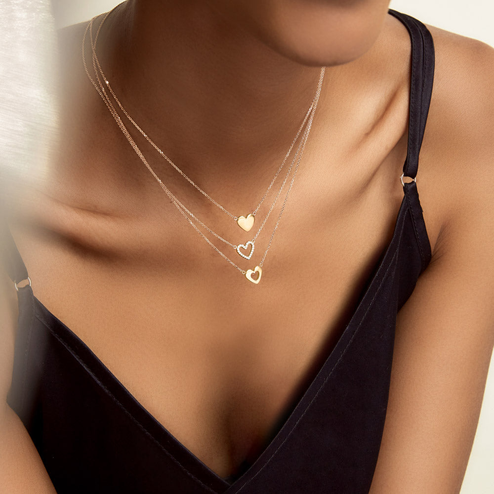 Model wearing Jewellers District's Heart Diamond Pavé Pendant Necklace in 10k Yellow Gold #5