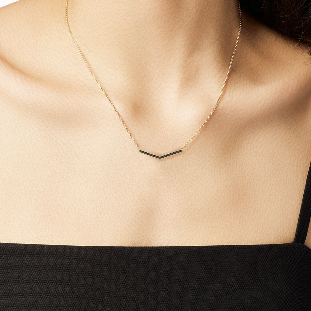 Model wearing Jewellers District's V-Shaped Gold Pendant Necklace with Black Spinels in 10k Yellow Gold #2