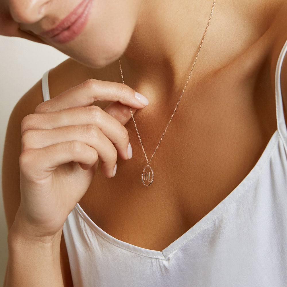 Model wearing Jewellers District's Gold Zodiac Charm Necklace: Scorpio in 14k Rose Gold #2