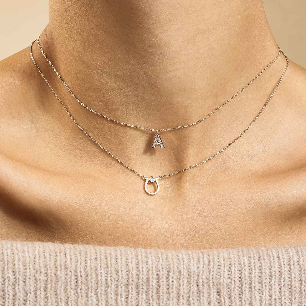 Model wearing Jewellers District's Horseshoe Pendant Necklace with Accent Diamond in 14k Rose Gold #3