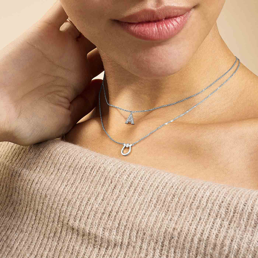 Model wearing Jewellers District's Horseshoe Pendant Necklace with Accent Diamond in 10k White Gold #2