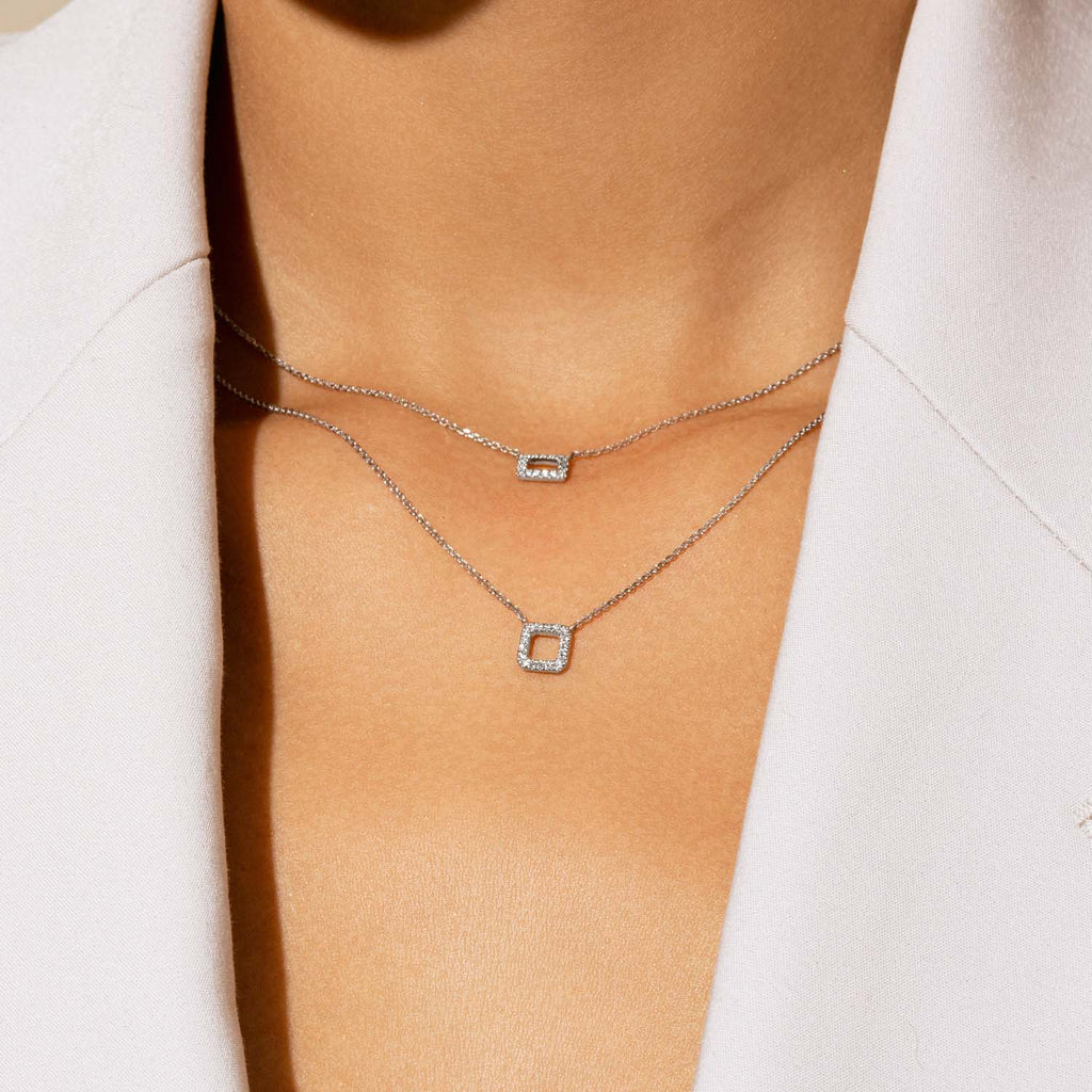 Model wearing Jewellers District's Square Diamond Pavé Pendant Necklace in 10k White Gold