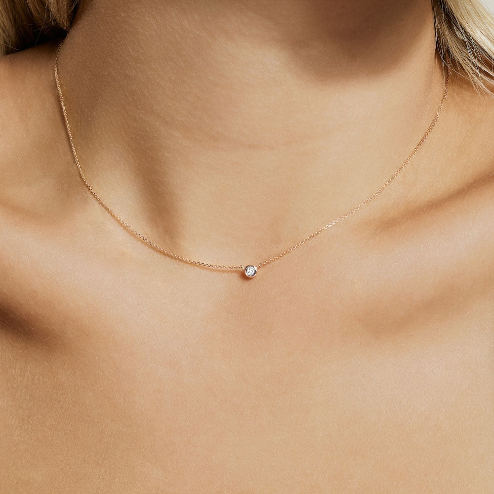 Model wearing Jewellers District's Bezel-Set Solitaire Diamond Necklace in 10k Rose Gold #2