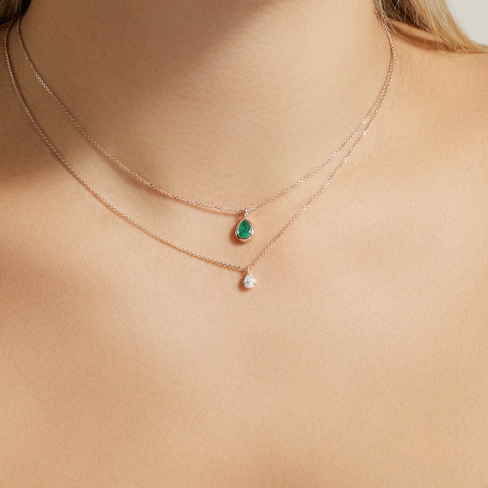 Model wearing Jewellers District's Bezel Set Pear-Cut Emerald Pendant Necklace in 10k Rose Gold